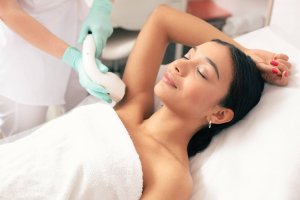 woman receiving laser hair removal on her underarms